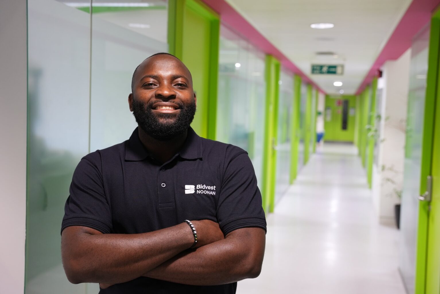 bidvest noonan cleaner standing proudly in a corporate setting