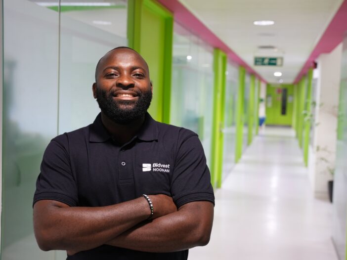 bidvest noonan cleaner standing proudly in a corporate setting